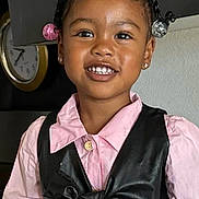 Wynter joined the competition — help win amazing prizes! child, smile, girl, portrait, indoor, clothing, pink_shirt, black_bow, hair_beads, earrings, face, happy, person, fashion, cute, kitchen, clock, cabinet, home, young