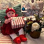 Jailyah joined the competition — help win amazing prizes! baby, celebration, child, christmas, cozy, cute, decorations, festive, floral_arrangement, gift, headband, holiday, holiday_spirit, indoors, pillow, present, red_clothing, sitting, white_tree, wrapped_gift