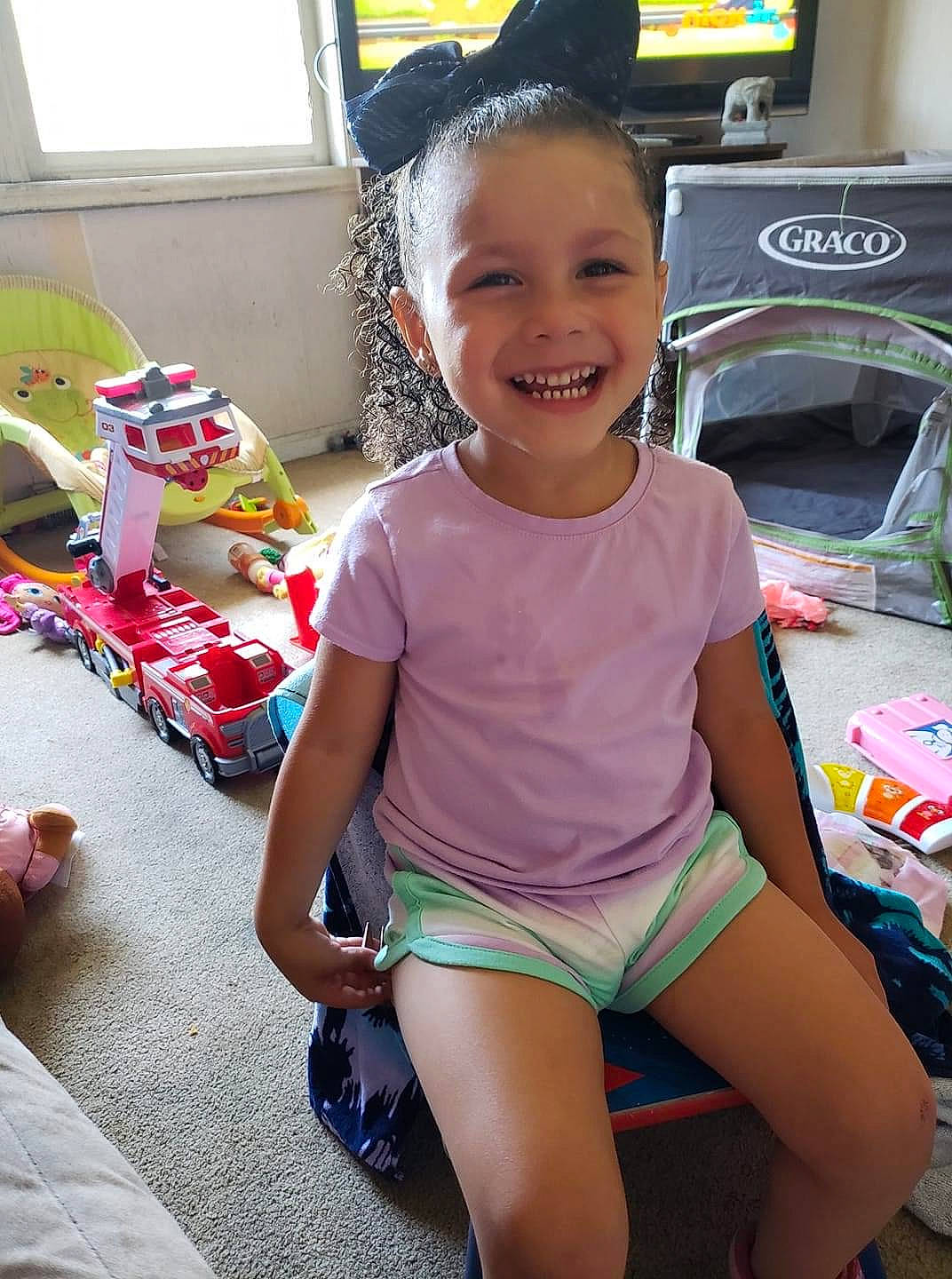 Jaylynn joined the competition — help win amazing prizes! baby_toddler_clothing, chest, child, finger, fun, happy, human_leg, joy, knee, leisure, magenta, person, pink, sitting, skin, smile, sportswear, swimwear, thigh, toddler
