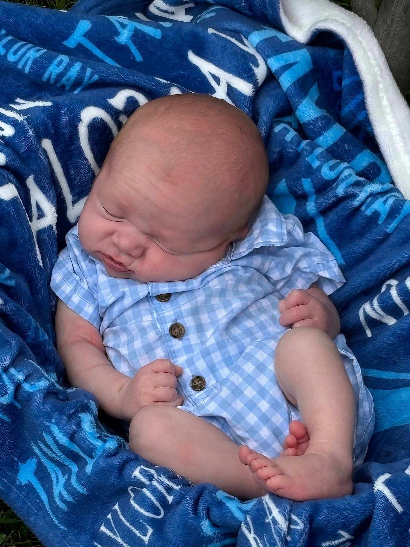 Taylor is registered to the contest to win money with this photo: baby, newborn, blanket, blue, clothing, infant, sleeping, peaceful, cute, soft, portrait, skin, small_hands, small_feet, outdoor, relaxing, child, resting, cozy, plaid