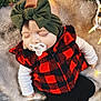 baby, blanket, cap, clothing, coat, costume, face, grass, hat, head, hood, jacket, knitwear, pants, person, photography, plant, portrait, scarf, sweater