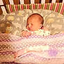 newborn, baby, sleeping, crib, blanket, bedding, animal_print, toddler, infant, bedroom, child, cute, peaceful, sleep, soft, pattern, colorful, pajamas, indoors, rest