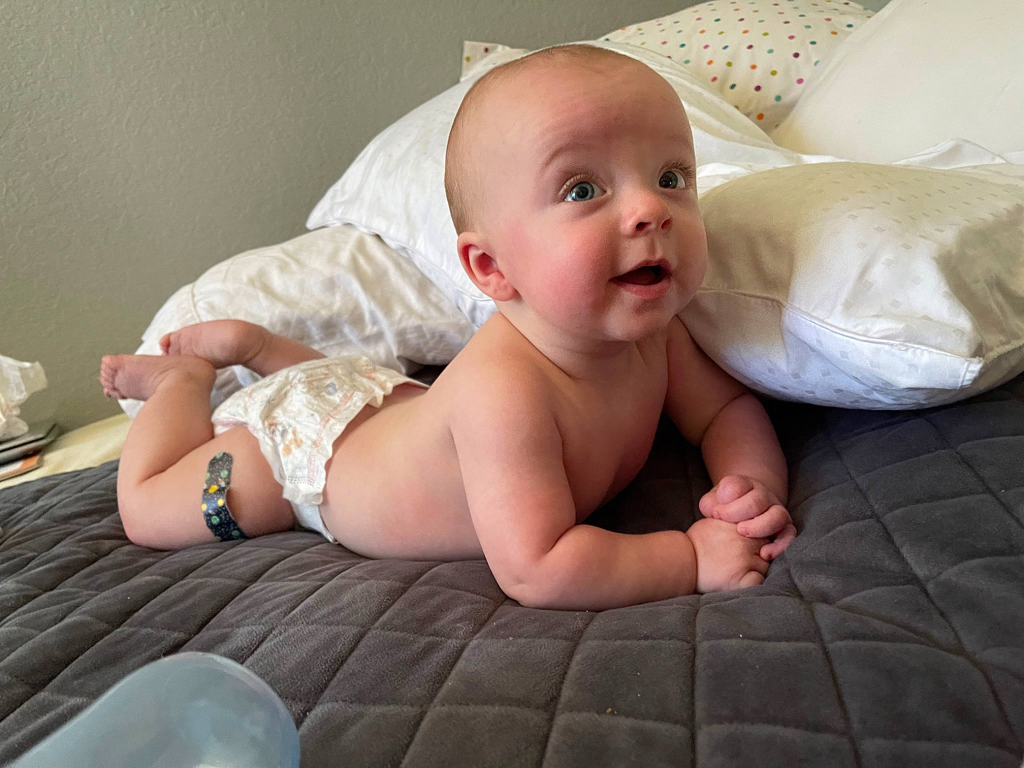 Spencer is registered to the contest to win money with this photo: abdomen, arm, baby, baby_toddler_clothing, child, comfort, finger, flash_photography, floor, flooring, foot, human_leg, iris, knee, mouth, person, sitting, skin, stomach, surprise