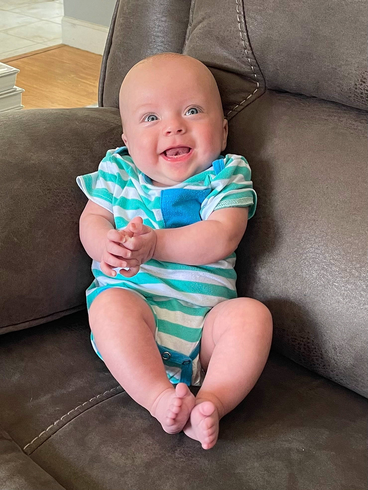 Spencer is registered to the contest to win money with this photo: aqua, baby, baby_toddler_clothing, child, comfort, couch, eye, face, flash_photography, happy, human_leg, iris, knee, lap, person, purple, skin, smile, textile, thigh