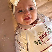 Raya joined the competition — help win amazing prizes! baby, infant, headband, bow, christmas, holiday, festive, smiling, cute, white_clothing, embroidery, face, lying_down, blanket, stars, child, young, indoors, portrait, happy