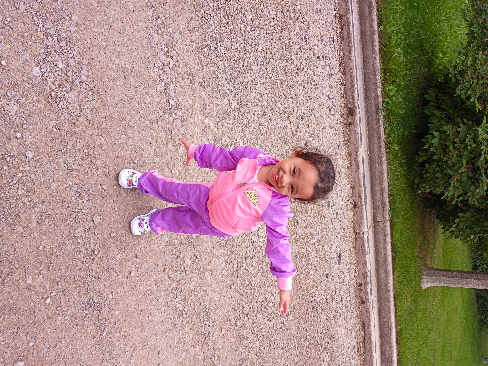 Layla is registered to the contest to win money with this photo: asphalt, baby_toddler_clothing, child, city, concrete, grass, joy, landscape, leisure, magenta, people_in_nature, person, pink, plant, purple, recreation, road_surface, soil, sunglasses, toddler