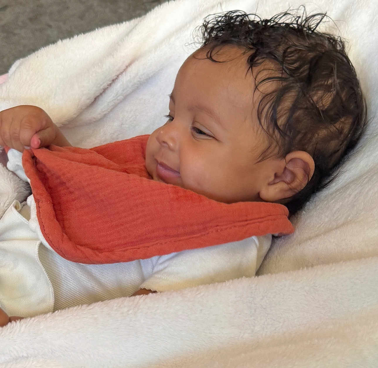 Geonna joined the competition — help win amazing prizes! baby, infant, smile, face, blanket, clothing, bib, cute, child, portrait, lying_down, soft_texture, happy, young, skin, head, hand, indoors, comfort, resting
