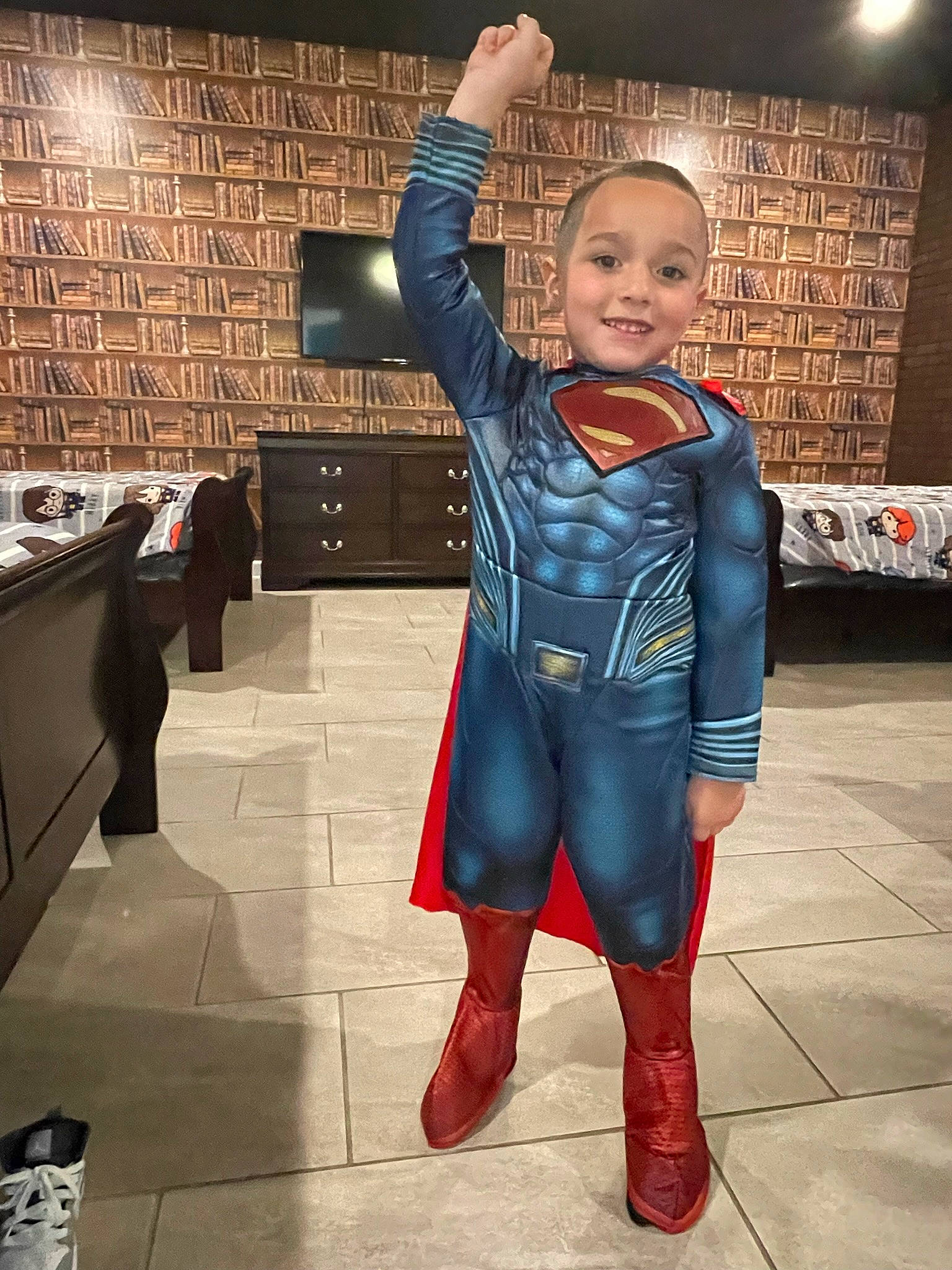 Isaiah is registered to the contest to win money with this photo: armour, belt, child, costume, electric_blue, event, eye, fictional_character, flash_photography, flooring, fun, gesture, happy, human_leg, joy, latex, person, personal_protective_equipment, sleeve, smile