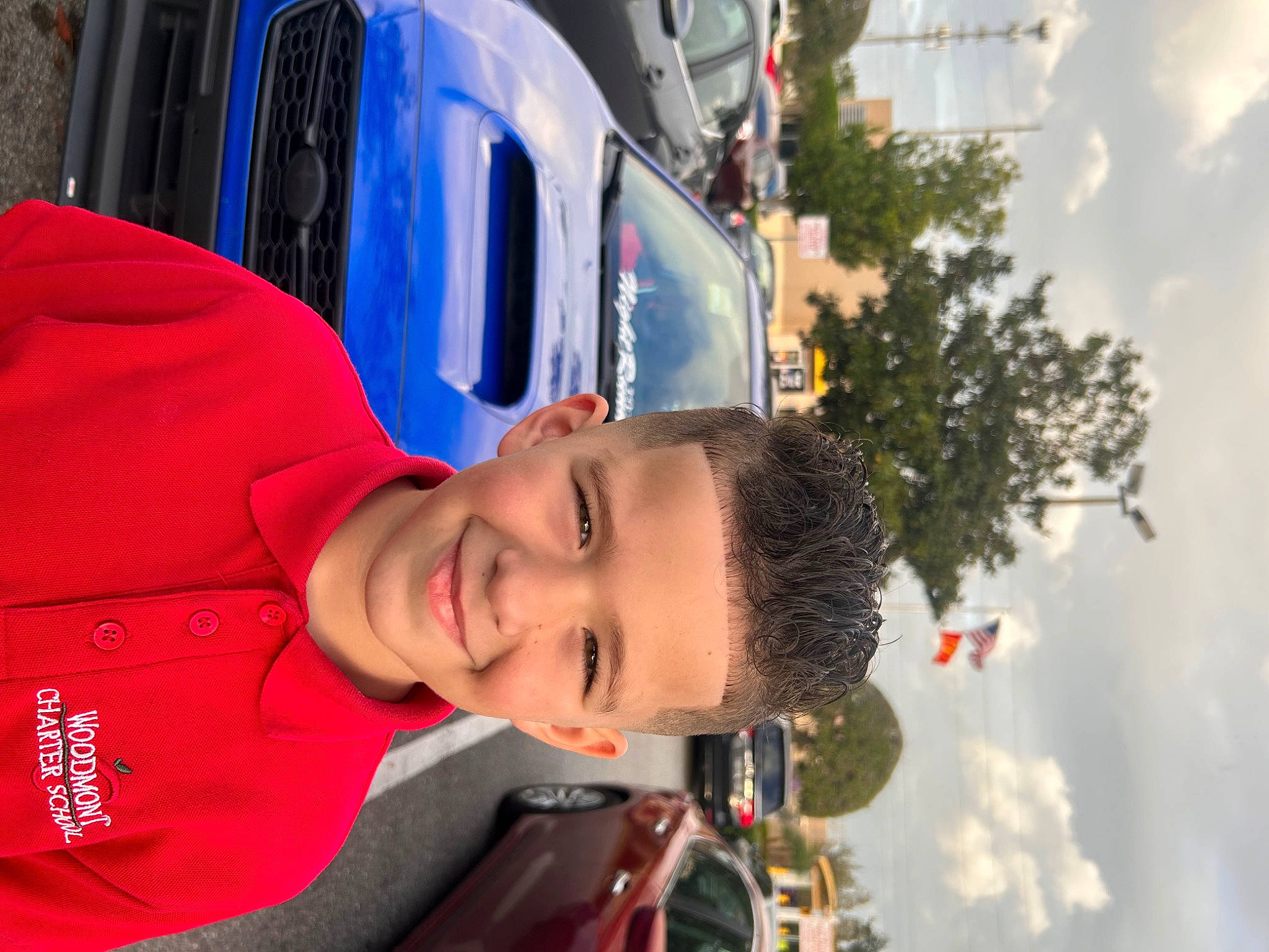 Samuel is registered to the contest to win money with this photo: automotive_design, automotive_exterior, car, cloud, electric_blue, family_car, fun, happy, joy, leisure, motor_vehicle, person, plant, recreation, sky, smile, sunglasses, travel, tree, vehicle