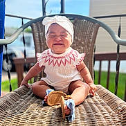 Rosalia is registered to the contest to win money with this photo: baby, cap, chair, clothing, face, footwear, furniture, hat, head, outdoorplayarea, outdoors, pants, person, photography, playarea, portrait, shoe, shorts, sitting, sunhat