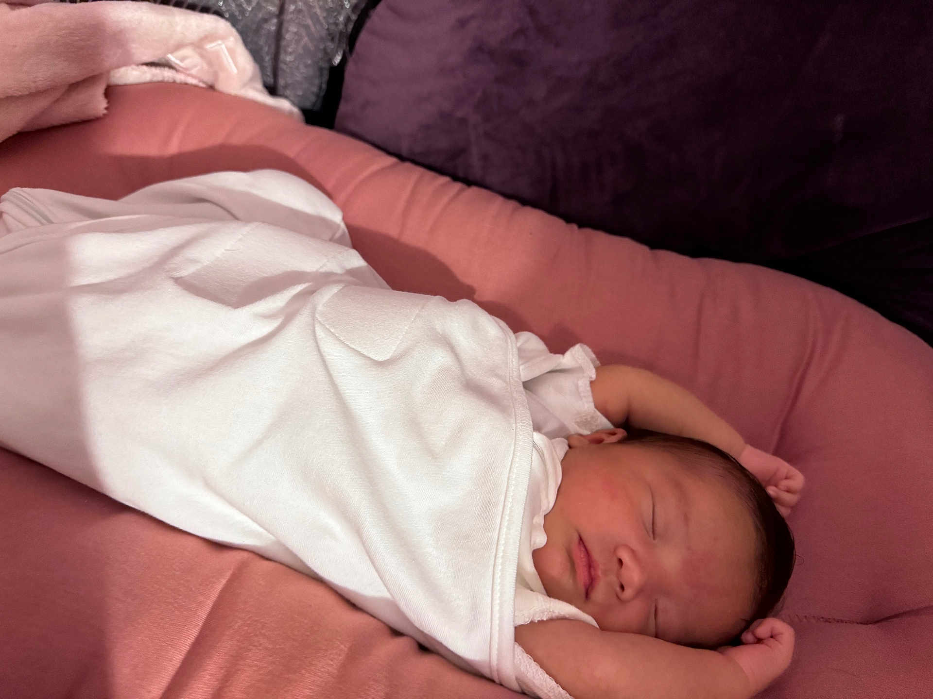 Leilani Rose joined the competition — help win amazing prizes! newborn, baby, sleeping, blanket, white_clothing, pink_cushion, soft_texture, infant, peaceful, resting, cozy, portrait, indoor, child, cute, wrapped, relaxed, small_hands, face, head