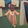 child, toddler, girl, standing, pink_dress, hair_bows, smiling, portrait, church, pews, indoor, carpet, wood, furniture, baby, fashion, outfit, shoes, adorable, photography