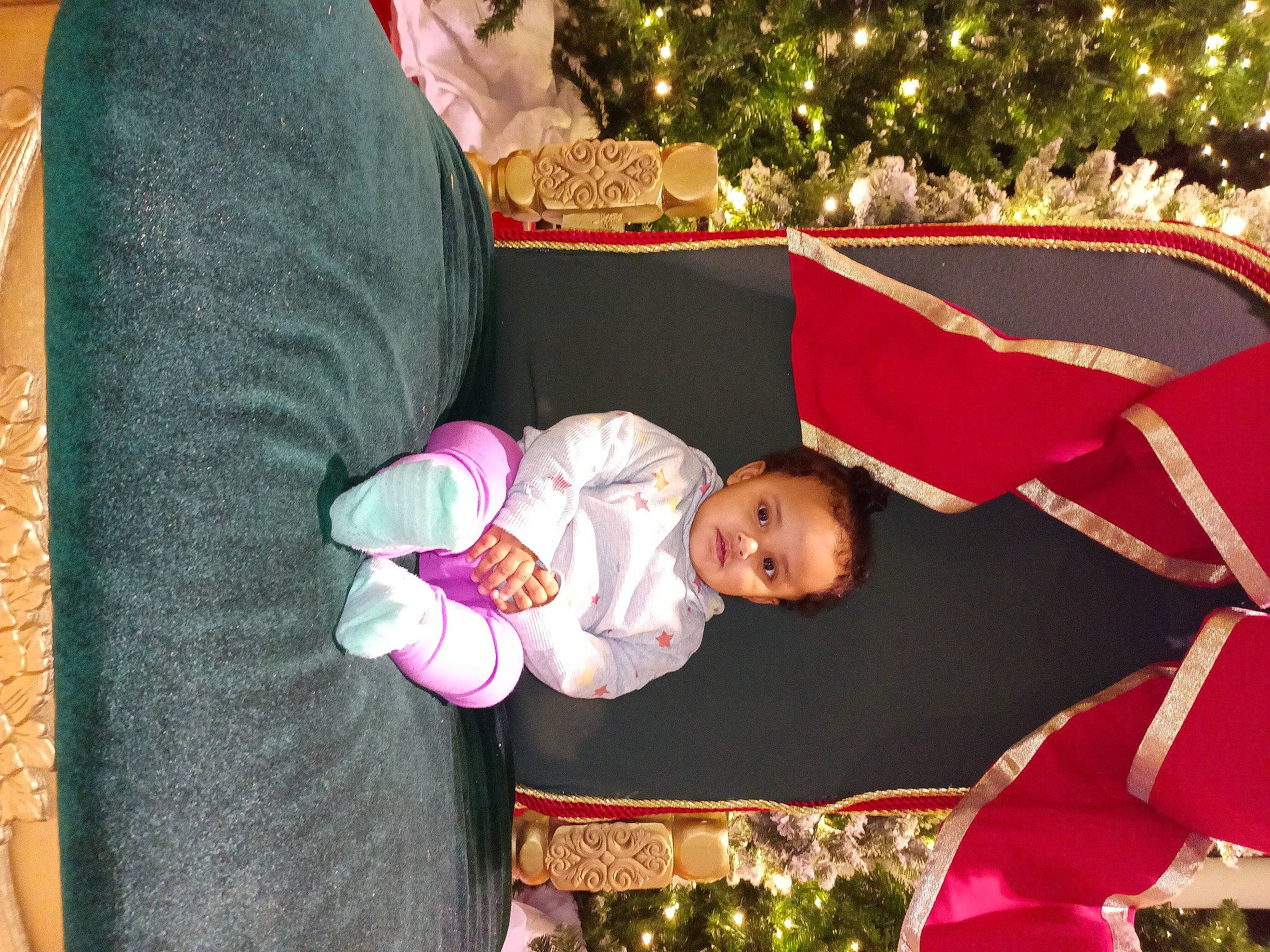 Anastacia is registered to the contest to win money with this photo: baby, baby_products, baby_toddler_clothing, child, christmas, christmas_decoration, christmas_eve, christmas_lights, christmas_ornament, christmas_tree, event, fun, happy, holiday, interior_design, lap, ornament, person, room, toddler