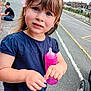 élina participe au concours pour gagner de l'argent avec cette photo : child, girl, baby_bottle, flower, blue_eyes, outdoor, street, sidewalk, boy, cap, brick_wall, casual_clothing, curious, hair, playing, urban, daytime, person, toddler, wheel