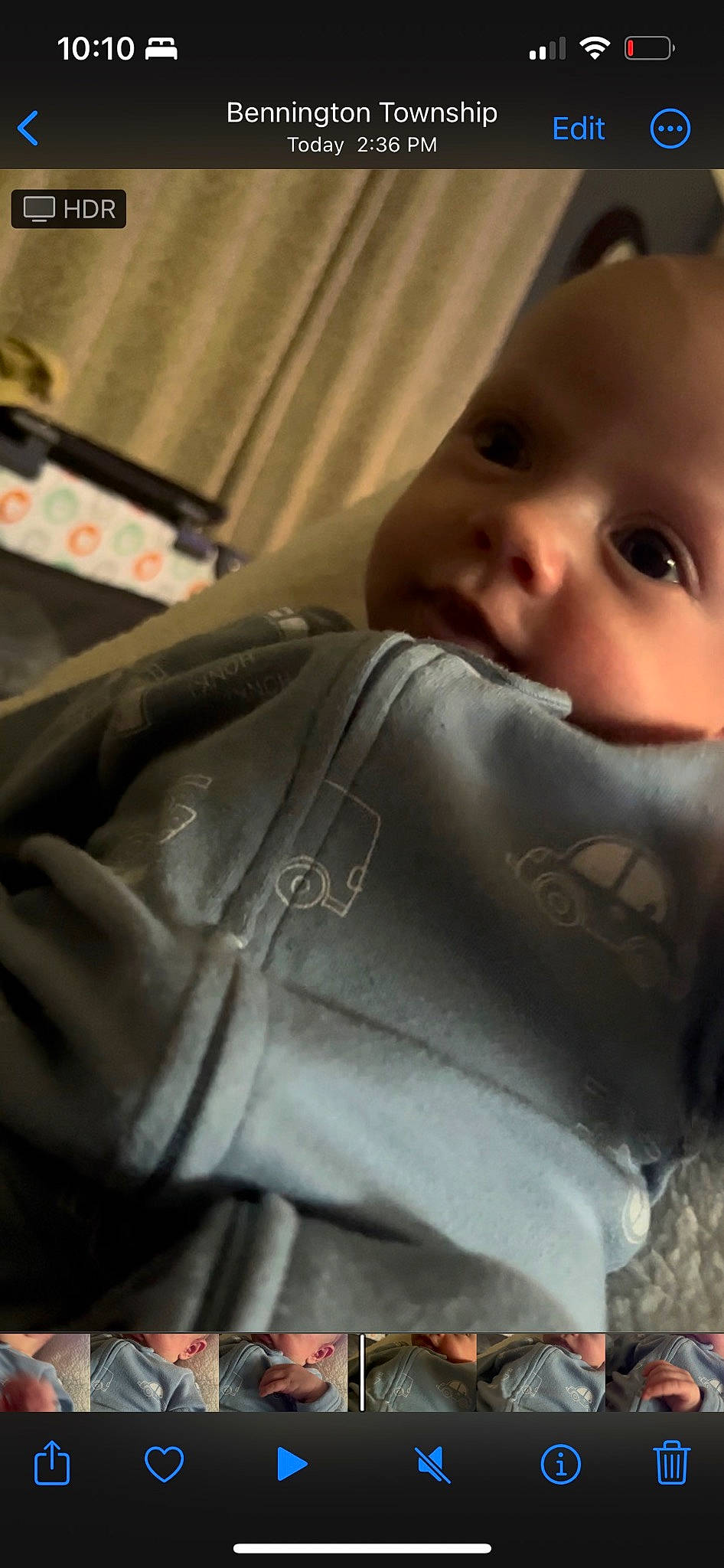 Emerson is registered to the contest to win money with this photo: baby, baby_toddler_clothing, cheek, child, comfort, face, finger, fun, hand, happy, head, human_body, human_leg, linens, nose, person, personal_protective_equipment, sitting, sleeve, toddler