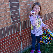 Elizabeth is registered to the contest to win money with this photo: architecture, bag, brick, building, child, clothing, face, female, footwear, girl, grass, head, outdoors, pants, person, photography, plant, portrait, shelter, shoe