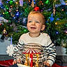 child, toddler, christmas_tree, holiday, snow_globe, decorations, lights, festive, smile, sweater, striped_clothing, indoors, toy, happy, seasonal, celebration, face, person, joy, winter