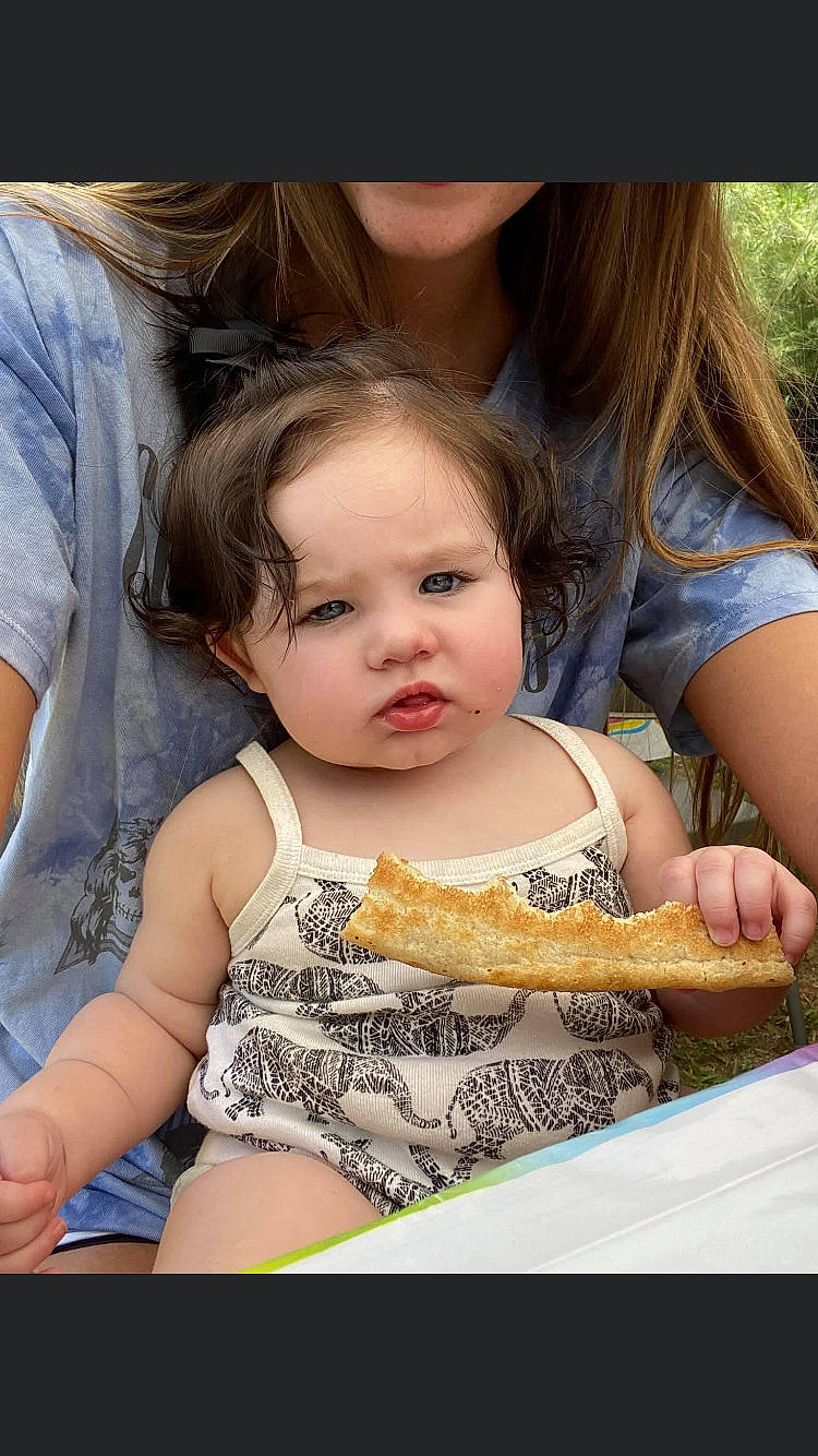 Remmi Lewis is registered to the contest to win money with this photo: baby, beauty, cheek, child, facial_expression, finger, food_craving, fun, grass, hairstyle, happy, iris, organ, person, sharing, sitting, skin, snapshot, summer, toddler