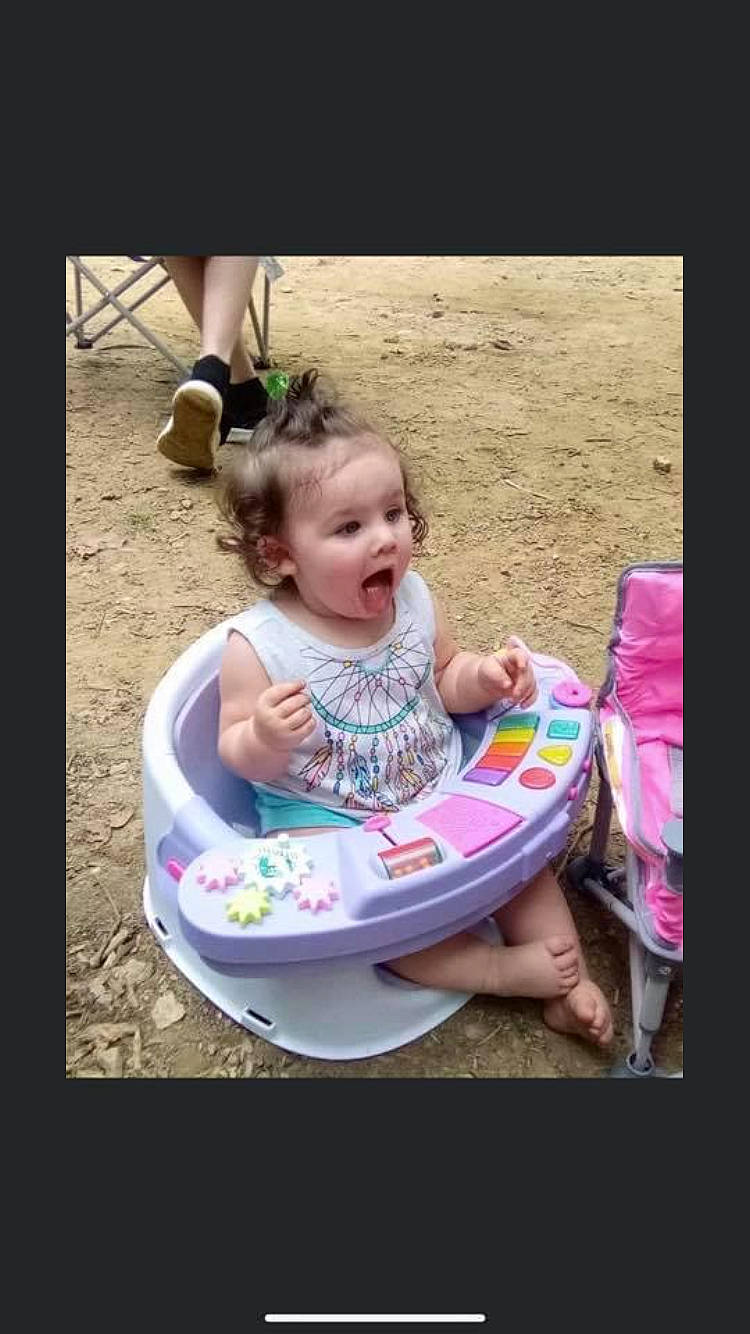 Remmi Lewis is registered to the contest to win money with this photo: baby, baby_products, baby_toddler_clothing, child, eyewear, face, fun, goggles, grass, happy, leisure, magenta, person, play, recreation, sharing, sitting, sunglasses, surprise, t_shirt