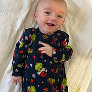 Leyton participe au concours pour gagner de l'argent avec cette photo : baby, infant, smiling, lying_down, onesie, grinch, holiday, christmas, blanket, cute, happy, face, person, child, young, indoors, clothing, fabric, hand, skin