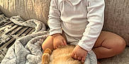 Ivan joined the competition — help win amazing prizes! blanket, cat, child, couch, cozy, domestic_animal, furniture, happy, home, indoor, natural_light, orange_cat, pet, relaxed, sitting, smiling, soft_texture, toddler, white_clothing, young_child