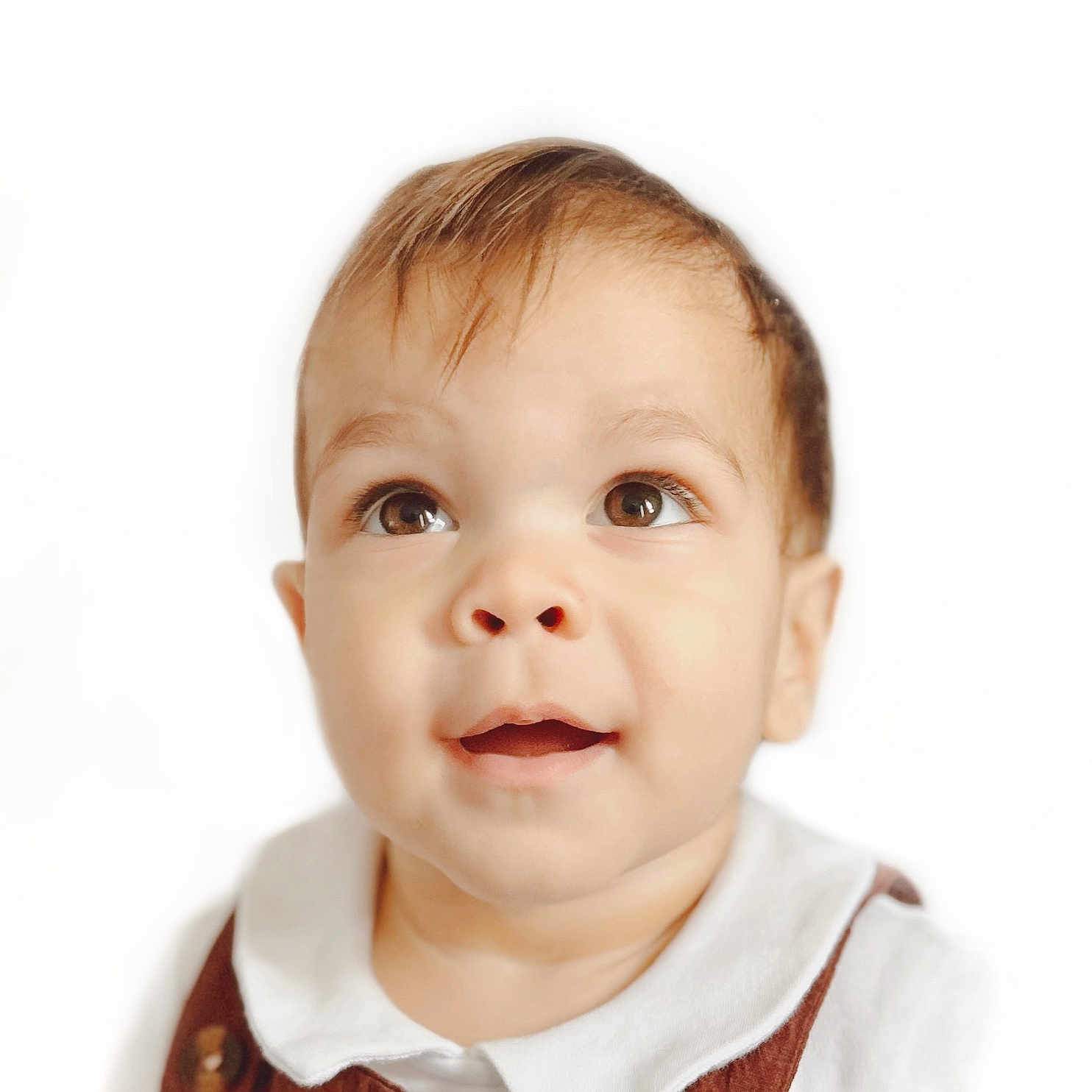 Ivan is registered to the contest to win money with this photo: adorable, baby, brown_eyes, button, child, close_up, collared_shirt, cute, expression, face, head_and_shoulders, infant, innocent, looking_up, overalls, portrait, smiling, soft_light, white_background, young_child