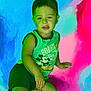 child, boy, green_shirt, mickey_mouse, shorts, colorful_background, abstract_art, blue, pink, red, casual_pose, smiling, portrait, indoor, young, person, artistic, vibrant, playful, relaxed