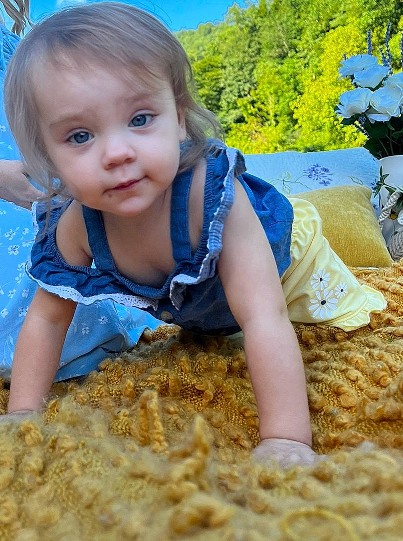 Evie joined the competition — help win amazing prizes! baby_toddler_clothing, blue, electric_blue, fun, grass, grass_family, happy, leisure, people_in_nature, person, plant, play, sand, sitting, sky, soil, sunlight, toddler, tree, wood