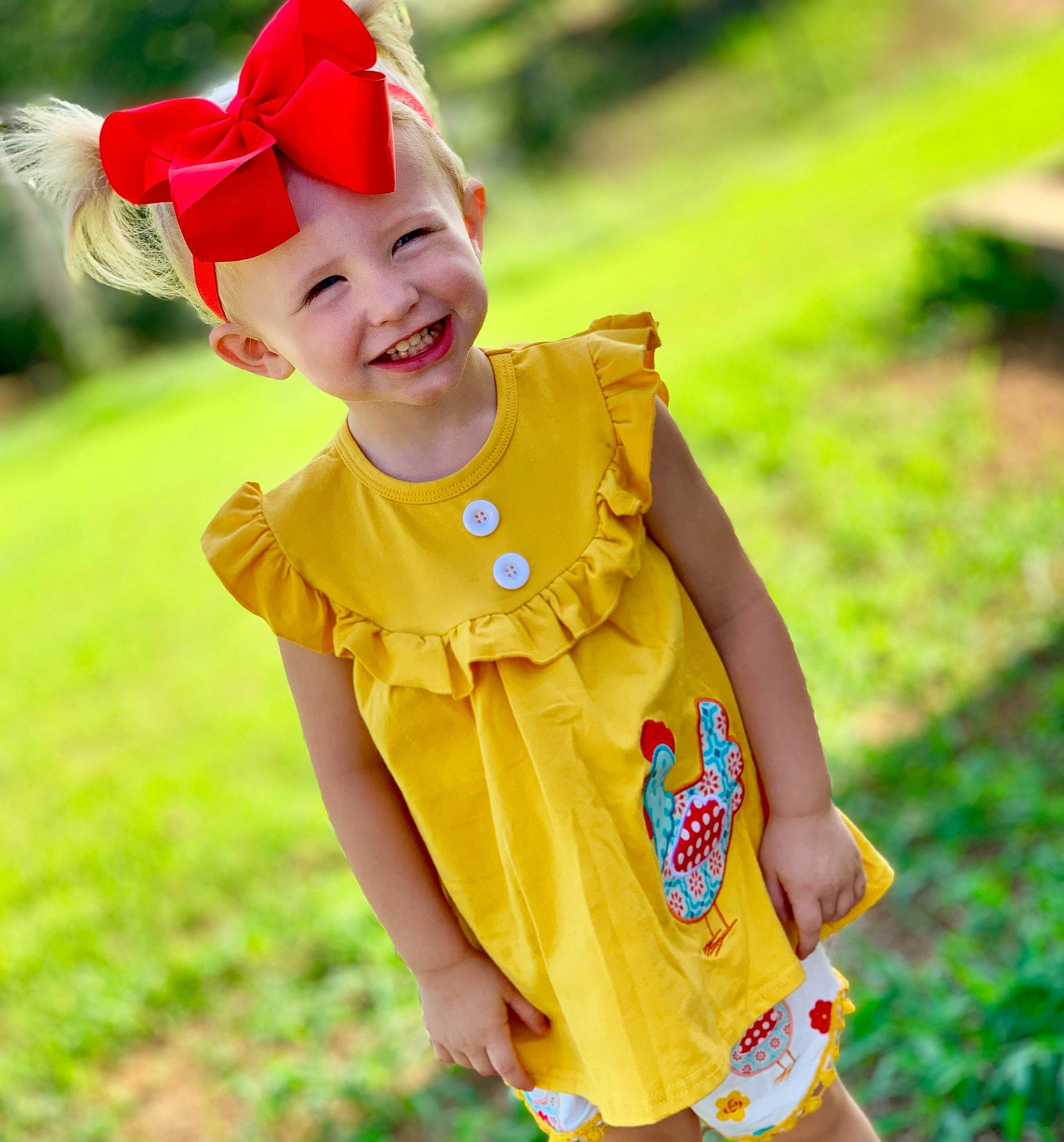 Addy joined the competition — help win amazing prizes! baby, child, child_model, clothing, dress, ear, happy, headband, headgear, joy, outerwear, pattern, person, plant, play, sleeve, smile, t_shirt, toddler, yellow