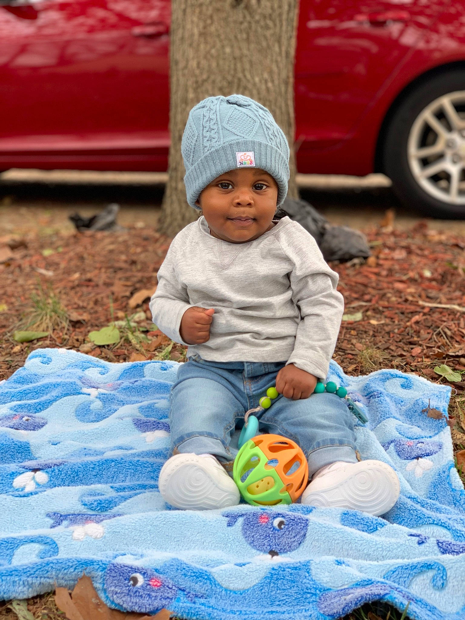 Daylen is registered to the contest to win money with this photo: blue, child, fun, grass, green, happy, headwear, leaf, leisure, light, morning, orange, people, person, photograph, product, red, smile, tire, toddler