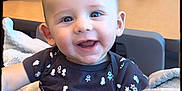 Greyson joined the competition — help win amazing prizes! adult, baby, babylaughing, clothing, couch, cutlery, face, female, furniture, happy, head, indoors, laughing, person, photography, portrait, sitting, smile, t_shirt, woman