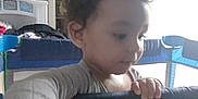 Ezekiel joined the competition — help win amazing prizes! child, toddler, curly_hair, playpen, graco, indoor, room, furniture, shelf, clothing, person, hand, face, baby, light, window, soft_light, curious, home, casual