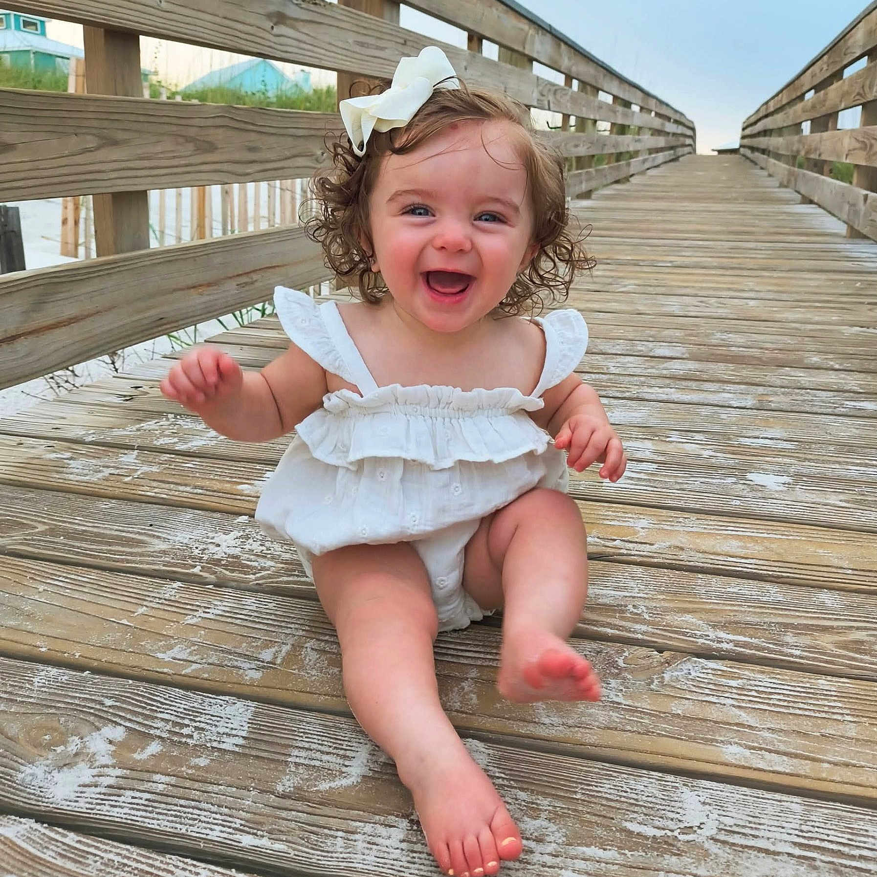 Remi joined the competition — help win amazing prizes! baby, barefoot, boardwalk, bow, child, curly_hair, cute, girl, happy, nature, outdoor, playful, portrait, sand, smiling, summer, sunset, vacation, white_dress, wooden