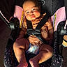 Evangeline joined the competition — help win amazing prizes! baby, car_seat, child, infant, seatbelt, pink, black, clothing, diaper, legs, feet, face, expression, indoors, light, shadow, straps, safety, cute, person
