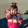Lyric joined the competition — help win amazing prizes! toddler, child, beach, sand, puffer_jacket, pink_clothing, white_clothing, pony_tail, outdoor, sunlight, shadow, curious_expression, holding_object, winter_clothing, person, portrait, young_child, casual_wear, daytime, fun