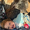 toddler, child, dog, smiling, bottle, blanket, floor, sunlight, indoor, happy, cute, pet, fur, pajamas, patterned, cozy, relaxed, playful, home, resting