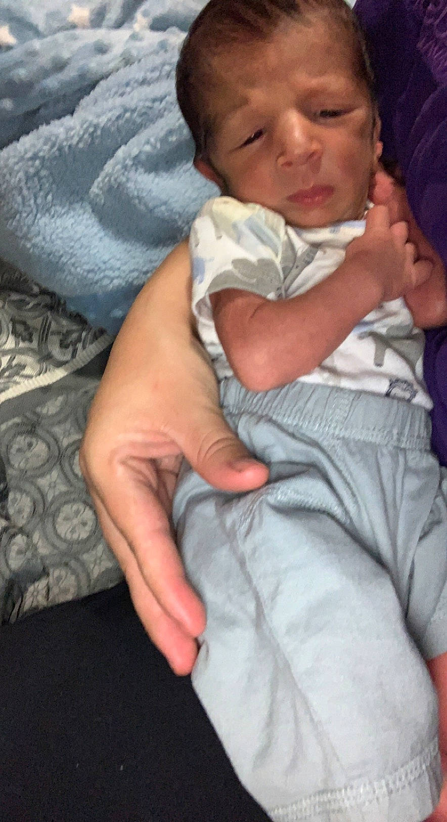 Kingston is registered to the contest to win money with this photo: baby, cheek, chest, child, comfort, elbow, finger, gesture, happy, hug, human_body, lap, linens, lip, mouth, nose, person, sitting, skin, thumb