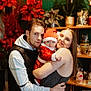 Diego a rejoint le concours — aidez-le/la à gagner de superbes lots ! baby, child, family, holiday, christmas, santa_claus_outfit, red_clothing, woman, man, hug, indoor, poinsettia, plant, shelf, decorations, smile, portrait, celebration, togetherness, love