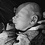 Diego participe au concours pour gagner de l'argent avec cette photo : baby, newborn, sleeping, face, hand, clothing, black_and_white, portrait, cozy, infant, peaceful, closeup, skin, person, toddler, rest, lying_down, human, cute, soft