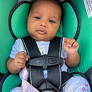 Olivia joined the competition — help win amazing prizes! baby, car_seat, child, infant, straps, pacifier, clothing, floral_pattern, cute, seat_belt, safety, pink, teal, hand, head, portrait, person, young_child, indoors, closeup