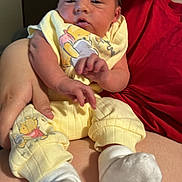 Katalyn joined the competition — help win amazing prizes! baby, infant, newborn, person, lap, yellow_clothing, socks, hand, arm, red_shirt, bottle, portrait, indoor, winnie_the_pooh, cozy, sitting, newborn_clothes, tiny_feet, skin, family_moment