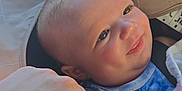 Octavius is registered to the contest to win money with this photo: baby, blanket, blue_clothing, car_seat, child, closeup, face, hand, happy, head, indoors, infant, person, portrait, seat, seatbelt, seatbelt_strap, skin, smile, sunlight