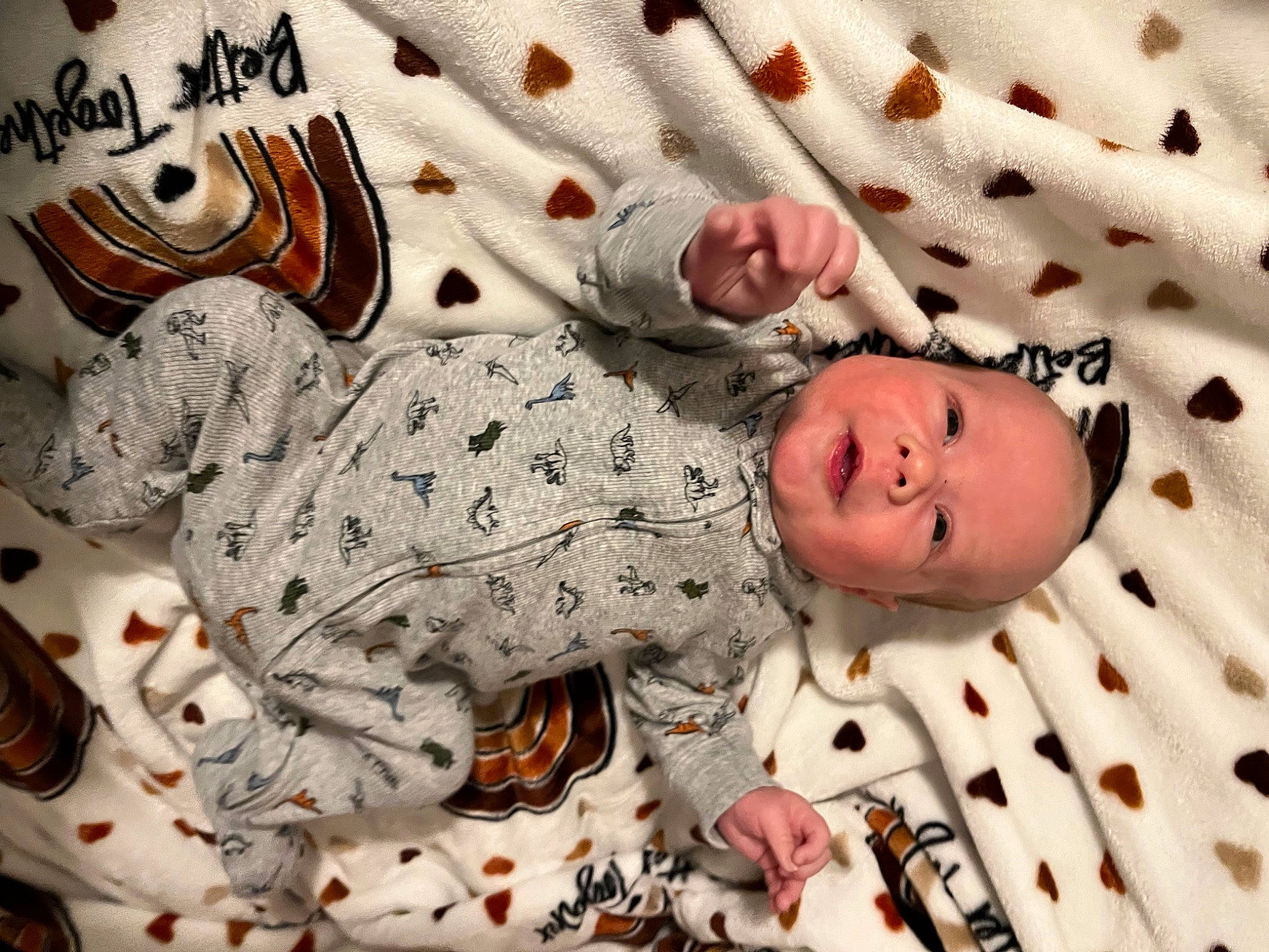 Liam is registered to the contest to win money with this photo: baby, baby_products, baby_safety, baby_toddler_clothing, bedding, child, comfort, face, facial_expression, linens, mammal, pattern, person, room, skin, sleeve, smile, textile, toddler, vertebrate