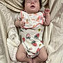 Braelyne is registered to the contest to win money with this photo: baby, infant, sleeping, onesie, bib, strawberry_pattern, blanket, bandage, foot, face, skin, hand, leg, bed, soft_texture, cute, peaceful, newborn, clothing, rest