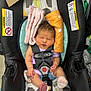 baby, newborn, car_seat, infant, safety_harness, sleeping, cloth, pink, orange, toothbrushes, package, footwear, socks, head_support, indoor, retail, product, warning_label, child, person