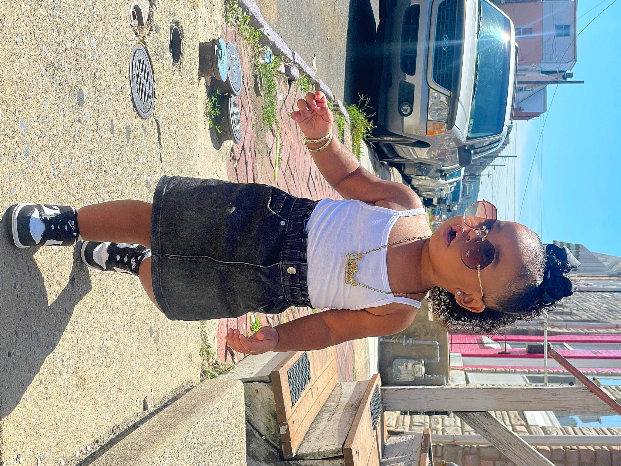 Kehlani joined the competition — help win amazing prizes! automotive_exterior, automotive_lighting, car, cool, electric_blue, eyewear, fun, hood, human_leg, knee, leisure, pedestrian, person, shorts, sky, sneakers, thigh, travel, vehicle, vehicle_door