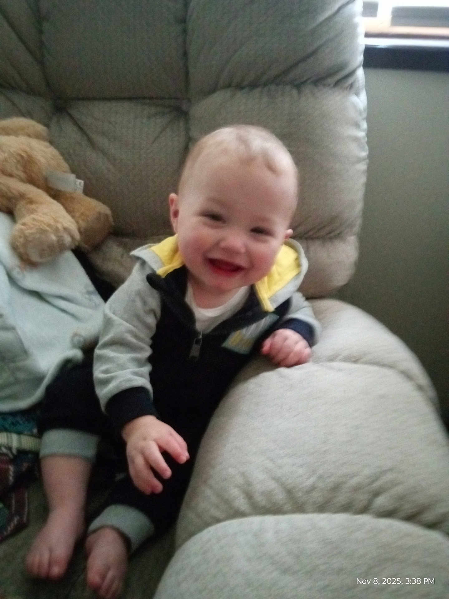 Onyx joined the competition — help win amazing prizes! baby, infant, smiling, child, recliner, armchair, couch, indoor, teddy_bear, plush_toy, onesie, hand, feet, happy, portrait, cozy, blurry, window, armrest, timestamp