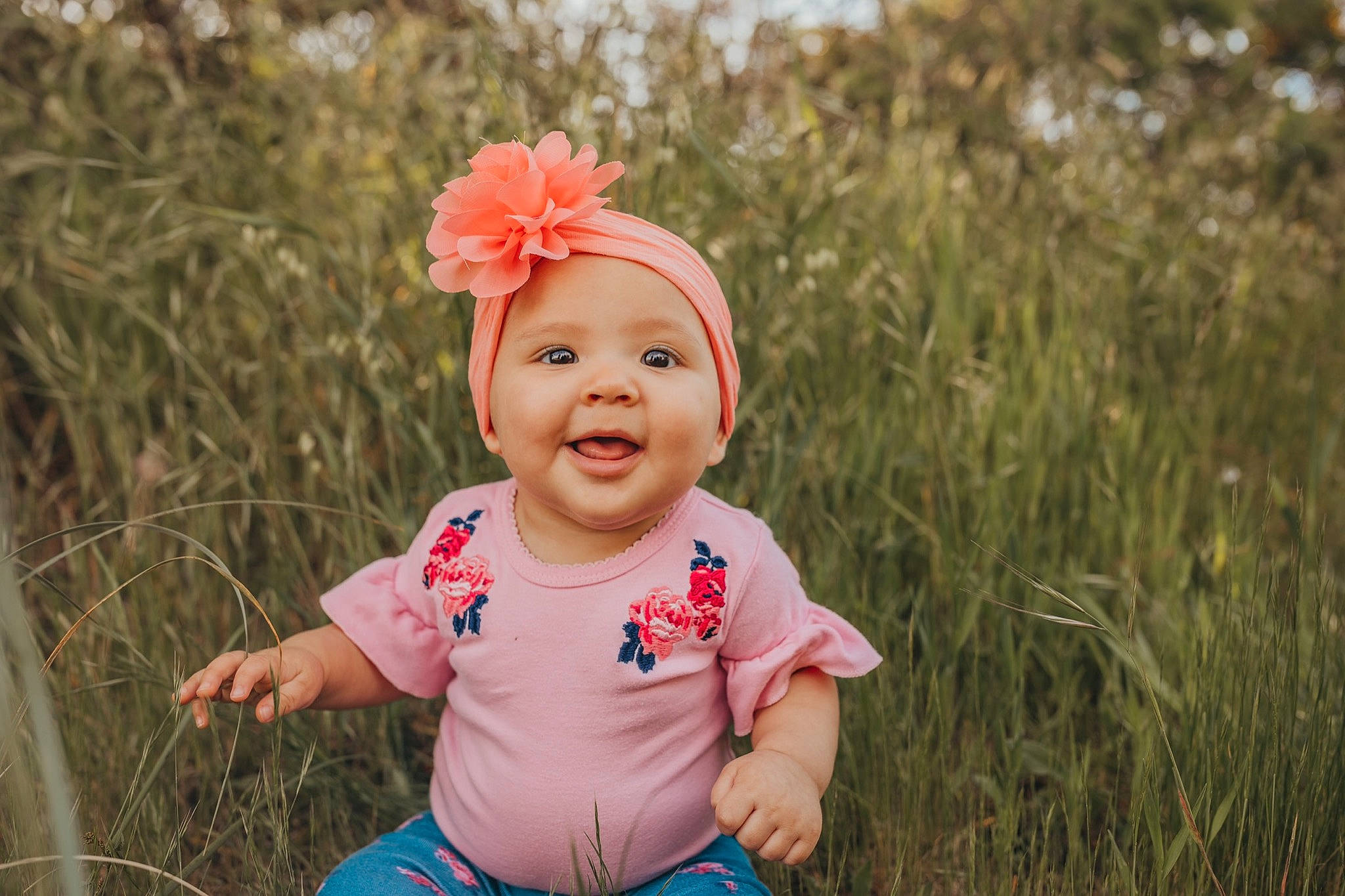 Mazikeen is registered to the contest to win money with this photo: baby, cheek, child, face, facial_expression, grass, grass_family, hair_accessory, happy, head, headwear, people, people_in_nature, person, photograph, photography, pink, red, skin, smile
