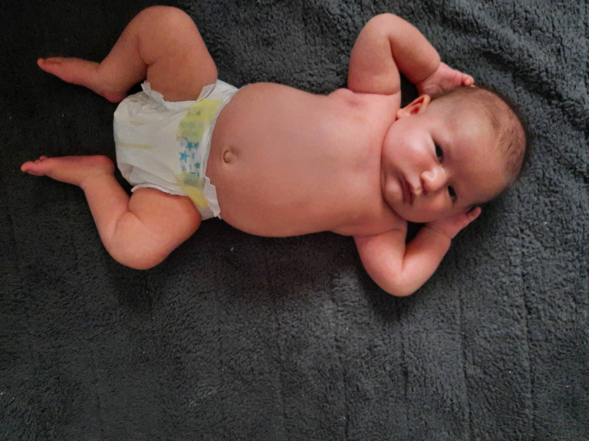 Jiraiya is registered to the contest to win money with this photo: abdomen, baby, baby_toddler_clothing, barefoot, chest, child, comfort, diaper, finger, foot, grass, head, human_body, pattern, person, skin, stomach, thigh, toddler, trunk