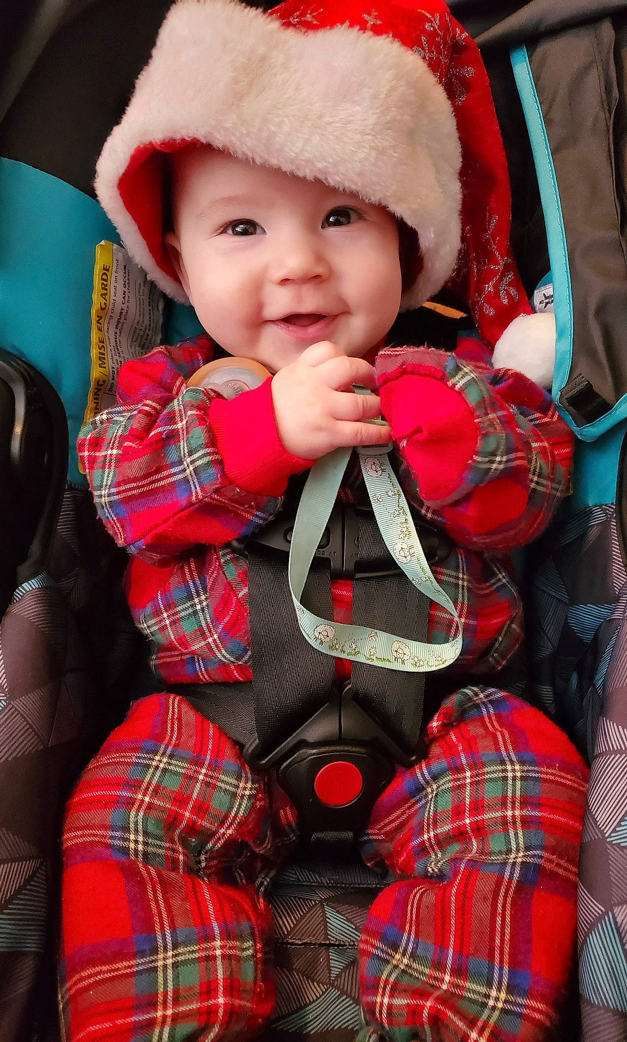 Michelangelo is registered to the contest to win money with this photo: baby, baby_toddler_clothing, black, cap, child, green, happy, head, headwear, outerwear, pattern, person, plaid, red, sleeve, smile, tartan, textile, thigh, toddler
